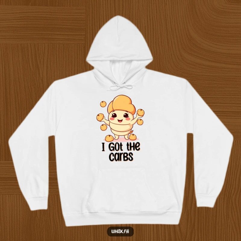 Funny hoodie featuring a smiling croissant character juggling tiny bread rolls, radiating warmth and pastry-inspired joy.
